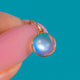 Rounded Moonstone cabochon with blue-white sheen in a Gold bezel